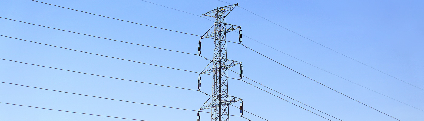 An electricity pylon against a blue sky
