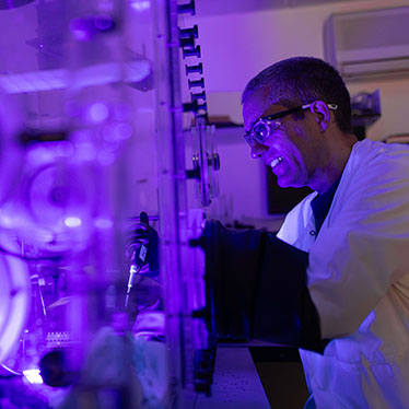 A scientist carries out work in an anaerobic glovebox.